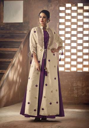 Here Is A Beautiful Designer Readymade Kurti With Jacket. Its Kurti Is In Purple Color Paired With Cream Colored Jacket. Its Kurti And Jacket Are Silk Based Beautified With Thread Work. 