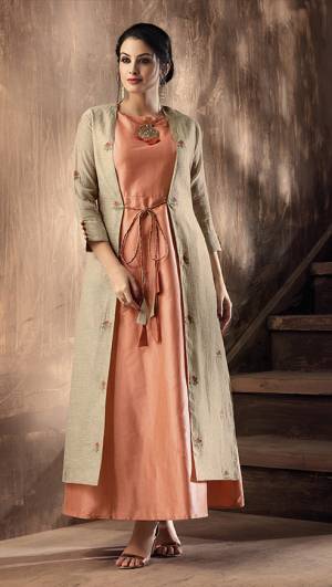A Must Have Shade In Every Womens Wardrobe Is Here With This Peach Colored Readymade kurti Paired With Beige Colored Jacket. Its Top Is Silk Based Paired With Cotton Silk Fabricated Jacket. Buy This Now.