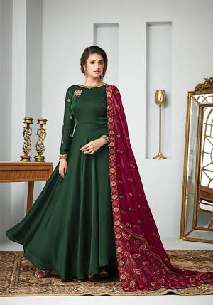 For A Bold And Beautiful Look, Grab This Designer Floor Length Suit In Dark Green Color paired with Maroon Colored Dupatta. Its Top Is Fabricated On Satin Georgette Paired With Santoon Bottom And Art Silk Dupatta. All Its Fabric Are Soft Towards Skin And Ensures Superb Comfort All Day Long. 