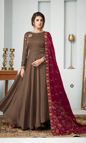 For A Bold And Beautiful Look, Grab This Designer Floor Length Suit In Beige Color paired with Maroon Colored Dupatta. Its Top Is Fabricated On Satin Georgette Paired With Santoon Bottom And Art Silk Dupatta. All Its Fabric Are Soft Towards Skin And Ensures Superb Comfort All Day Long. 