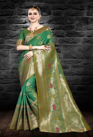 Grab This Beautiful Silk Based Saree In Green Color Paired With Green Colored Blouse. This Saree And Blouse Are Fabricated On Art Silk Beautified With Weave All Over It. 
