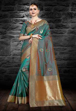 Add This Pretty Shade To Your Wardrobe With This Saree In Teal Blue Color Paired With Teal Blue Colored Blouse. This Saree And Blouse Are Fabricated On Art Silk Beautified With Weave All Over.