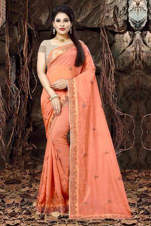 Celebrate This Festive Season Wearing This Designer Saree In Orange Color Paired With Sand Grey Colored Blouse. This Saree Is Fabricated On Linen Orgenza Paired With Art Silk Fabricated Blouse. It Is Beautified With Attractive Jari Embroidery. 