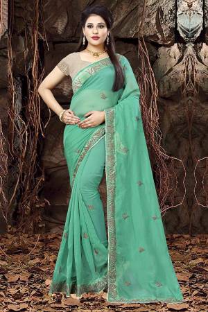 Here Is A Very Pretty Designer Saree In Sea Green Color Paired With Sand Grey Colored Blouse. This Saree Is Fabricated On Linen Orgenza Paired With Art Silk Fabricated Blouse. 