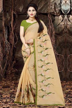 Celebrate This Festive Season Wearing This Designer Saree In Light Orange Color Paired With Green Colored Blouse. This Saree Is Fabricated On Orgenza Paired With Art Silk Fabricated Blouse. It Is Beautified With Attractive Jari Embroidery. 