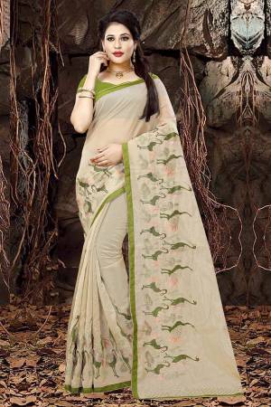 Flaunt Your Rich And Elegant Taste In This Designer Saree With Lovely Color Pallete, This Saree Is In Cream Color Paired With Green Colored Blouse, It Is Fabricated On Orgenza Paired With Art Silk Fabricated Blouse. Buy Now.