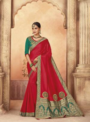 Bright And Visually Appealing Color Is Here With This Designer Saree In Red Color Paired With Contrasting Teal Green Colored Blouse. This Saree And Blouse Are Silk Based Which Also Gives A Rich Look To Your Personality. 