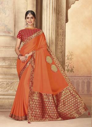 Bright And Visually Appealing Color Is Here With This Designer Saree In Orange Color Paired With Red Colored Blouse. This Saree And Blouse Are Silk Based Which Also Gives A Rich Look To Your Personality. 