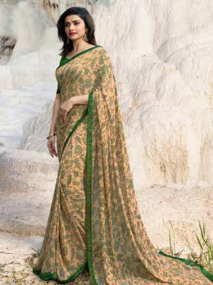 Simple And Elegant Looking Saree Is Here In Light Peach Color Paired With Contrasting Dark Green Colored Blouse, This Saree Is Georgette Based Paired With Art Silk Fabricated Blouse. It Is Beautified With Floral Prints All Over. 