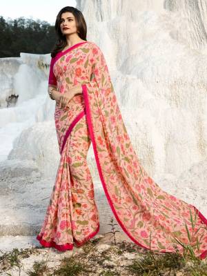 Here Is A Very Pretty Floral Printed Saree In Baby Pink Color Paired With Dark Pink Colored Blouse. This Saree Is Fabricated On Georgette Paired With Art Silk Fabricated Blouse. It Is Beautified With Prints And Lace Border. 