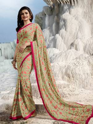 Grab This Very Pretty Floral Printed Saree In Pastel Green Color Paired With Dark Pink Colored Blouse. This Saree Is Fabricated On Georgette Paired With Art silk Fabricated Blouse. 