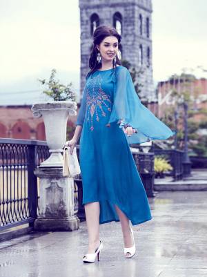 Here Is An Attractive Designer Kurti In Blue Color. This Silk Based Kurti Is Beautified With Thread Embroidery and Lovely Sleeve Pattern. This Kurti Has Rich Soft Fluid Silk Fabric Which Ensures Superb Comfort All Day Long.