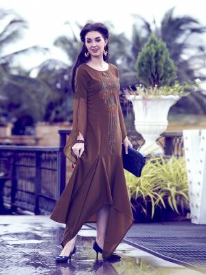 Enhance Your Personality Wearing This Designer Readymade Kurti In Brown Color Which Is Soft Fluid Silk Based. This Kurti has Unique Pattern Over The Hem With A Lovely Sleeve Pattern. This Kurti Is Available All Regular Sizes. Buy Now.