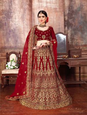 Get Ready For The D-Day With This Heavy designer Lehenga Choli In Full Maroon Color. This Lehenga Choli Is Fabricated On Velvet Paired With Net Fabricated Dupatta. It Is Beautified With Heavy Embroidery Which Is Giving This Lehenga More Graceful Look. 