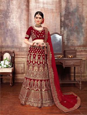 Get Ready For The D-Day With This Heavy designer Lehenga Choli In Full Maroon Color. This Lehenga Choli Is Fabricated On Velvet Paired With Net Fabricated Dupatta. It Is Beautified With Heavy Embroidery Which Is Giving This Lehenga More Graceful Look. 