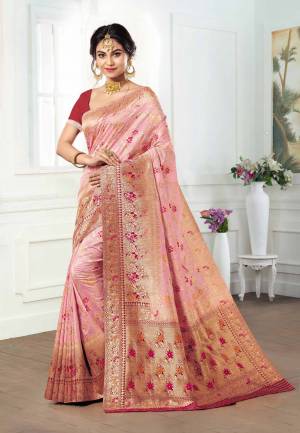 Look Pretty Wearing This Designer Silk Based Saree In Baby Pink Color Paired With Dark Pink Colored Blouse. This Saree And Blouse Are Fabricated On Kanjivaram Art Silk Beautified With Weave All Over. 