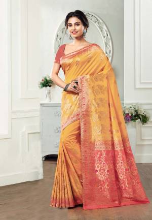 Get Ready For The Upcoming Festive And Wedding Season Wearing This Silk Based Saree In Musturd Yellow Color Paired With Contrasting Peach Colored Blouse. This Saree And Blouse Are Fabricated On Kanjivaram Art Silk Beautified With Weave All Over. 