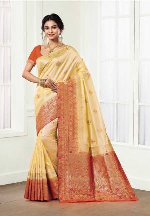 Celebrate This Festive Season Wearing This Designer Silk Based Saree In Light Yellow Color Paired With Contrasting Orange Colored Blouse. This Saree And Blouse Are Fabricated On Kanjivaram Art Silk Beautified With Weave All Over It. 