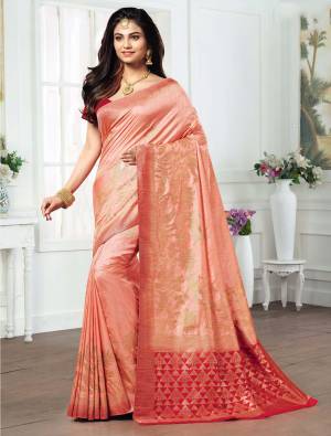 Here Is A Very Pretty Peach Colored Saree Paired With Contrasting Red Colored Blouse. This Saree And Blouse Are Fabricated On Kanjivaram Art Silk Beautified With Weave All Over. 