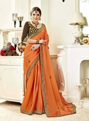 Shine Bright Wearing This Designer Saree In Orange Color Paired With Contrasting Brown Colored Blouse. This Saree Is Fabricated On Georgette Paired With Art Silk Fabricated Blouse.