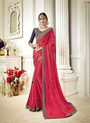Adorn This Attractive looking Designer Saree In Dark Pink Color Paired With Contrasting Navy Blue Colored Blouse. This Saree Is Fabricated On Georgette Paired With Art Silk Fabricated Blouse. It Is Beutified With Embroidery Over Blouse And Tassels Over The Saree. 