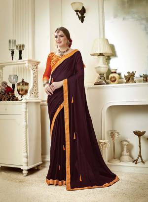 New And A Must Have Shade In Every Womens Wardrobe Is Here With This Designer Saree In Dark Wine Color Paired With Contrasting Orange Colored Blouse. This Saree Is Fabricated On Georgette Paired With Art Silk Fabricated Blouse. 