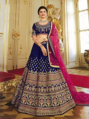 Enhance Your Personality Wearing This Heavy Designer Lehenga Choli In Navy Blue Color Paired With Contrasting Dark Pink Colored Blouse. This Saree And Blouse Are Art Silk Based Paired With Orgenza Fabricated Dupatta. It Has Heavy Embroidery All Over Giving It An Attractive Look.