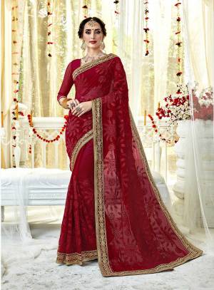 Add This Beautiful Designer Saree In Red Color Paired With Red Colored Blouse. This Saree And Blouse Are Georgette Based Beautified With Tone To Tone Embroidery All Over Heavy Embroidered Lace Border. 