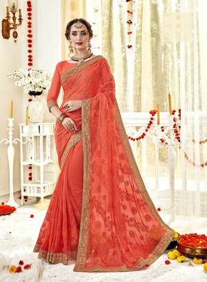 Celebrate This Festive Season Wearing This Heavy Designer Saree In Orange Color Paired With Orange Colored Blouse. This Saree And Blouse Are Georgette Based With Pretty Tone On Tone Work. 