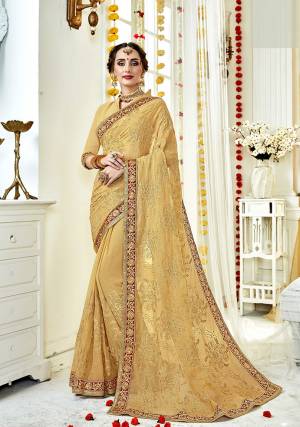 Here Is A Rich And Elegant Looking Shade With This Designer Saree In Beige Color Paired With Beige Colored Blouse. This Saree And Blouse Are Fabricated On Georgette Beautified With Tone To Tone Embroidery.