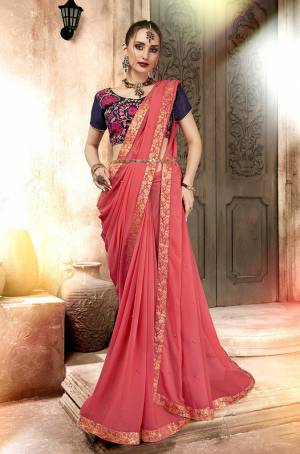 Look Pretty In This Designer Pink Colored Saree Paired With Contrasting Navy Blue Colored Blouse. This Saree Is Fabricated On Satin Georgette Paired With Art Silk Fabricated Blouse. It Has Embroidered Blouse With Plain Saree. 