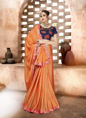 Look Pretty In This Designer Orange Colored Saree Paired With Contrasting Navy Blue Colored Blouse. This Saree Is Fabricated On Satin Georgette Paired With Art Silk Fabricated Blouse. It Has Embroidered Blouse With Plain Saree. 