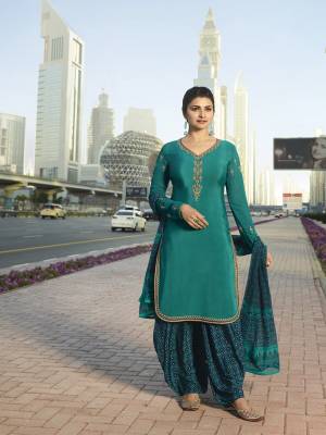 Add This Beautiful Designer Semi-Stitched Suit To Your Wardrobe In Shades Of Blue. This Pretty Suit Is In Teal Blue Color Paired With Navy Blue Colored Bottom And Dupatta. Its Top And Bottom Are Fabricated On Crepe Paired With Chiffon Dupatta.