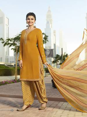 This Festive Season, Catch All The Attention Wearing This Designer Suit In Musturd Yellow Color Paired With Cream Colored Bottom And Dupatta. Its Top And Bottom Are Fabricated On Crepe Paired With Chiffon Dupatta. All Its Fabrics Ensures Superb Comfort All Day Long. 
