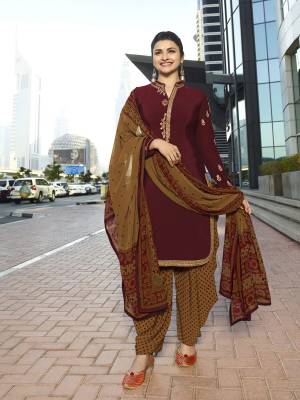 For A Royal Look, Grab This Designer Semi-Stitched Suit In Maroon Colored Top Paired With Contrasting Light Brown Colored Bottom And Dupatta. Its Top And Bottom Are Crepe Fabricated Paired With Chiffon Dupatta. Buy This Suit Now.