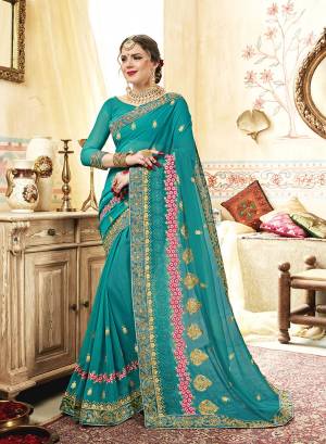 Here Is A Very Pretty Designer Saree In Turquoise Blue Color Paired With Turquoise Blue Colored Blouse. This Saree And Blouse Are Georgette Based Beautified With Heavy Jari And Thread Work. 