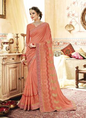 A Must Have Shade In Every Womens Wardrobe Is Here With This Designer Saree In Peach Color Paired With Peach Colored Blouse. This Saree And Blouse Are Fabricated On Georgette Beautified With Jari And Thread Embroidery With Stone Work. 