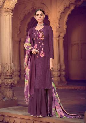 Wine colored muslin silk fabric suit comes with matching colored santoon Solid bottom with printed dupatta. This suit is covered with floral print with touc of thread work on top. Team it with a sandles to create a contrasting effect.