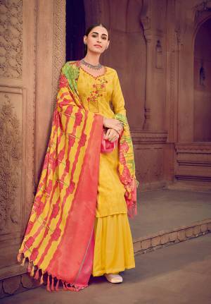 Yellow color muslin silk fabric suit comes with matching colored santoon Solid bottom with printed dupatta. This suit is covered with floral print with touc of thread work on top. Team it with a sandles to create a contrasting effect.