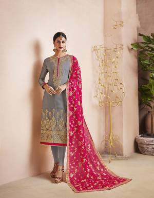 Flaunt Your Rich And Elegant Taste Wearing This Heavy Designer Suit In Grey Color Paired With Dark Pink Colored Dupatta. Its Top Is Fabricated On Georgette Satin Paired With Santoon Bottom And Orgenza Fabricated Dupatta. It Is Beautified With Heavy Embroidery Over The Top And Dupatta. 