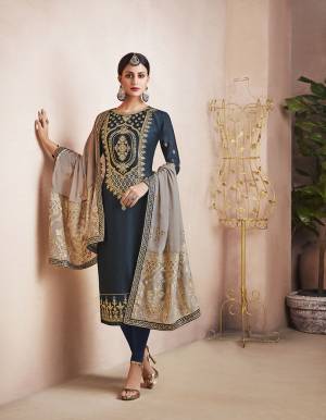 Enhance Your Personality Wearing This Designer Heavy Straight Suit In Navy Blue Color Paired With Contrasting Grey Colored Dupatta. Its Top Is Fabricated On Georgette Satin Paired With Santoon Bottom And Orgenza Based Dupatta. Its Rich Color Pallete And Heavy Embroidery Over The Top And Dupatta Will Earn You Lots Of compliments From Onlookers. 