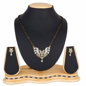 Give An Elegant Look To Your Neckline Wearing This Rich Delicate Patterned Designer Magalsutra Set. It Is Beautified With Pretty Diamond Work Giving It An Attractive Look. 