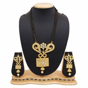 For A Heavy Look, Grab This Heavy designer Mangalsutra Set In Golden Color Beautified With Stone work. This Can Be Paired With Any Colored Heavy Ethnic Attire. Buy Now.