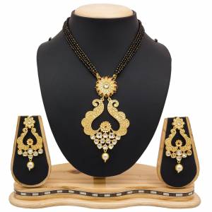 For A Heavy Look, Grab This Heavy designer Mangalsutra Set In Golden Color Beautified With Stone work. This Can Be Paired With Any Colored Heavy Ethnic Attire. Buy Now.
