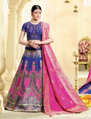 For A Classy Look, Grab This Designer Lehenga Choli In Blue Color Paired With Contrasting Dark Pink Colored Dupatta. Its Blouse IS Fabricated On Art Silk Paired With Jacquard Silk Fabricated Lehenga And Dupatta. Its Lovely Silk Fabric Will Give A Rich Look To Your Personality. 