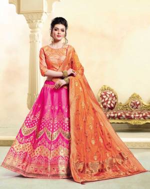 Bright And Visually Appealing Color Is Here With This Designer Lehenga Choli In Orange Colored Blouse And Dupatta Paired With Dark Pink Colored Lehenga. Its Blouse Is Art Silk Based Paired With Jacquard Silk Fabricated Lehenga And Dupatta. 