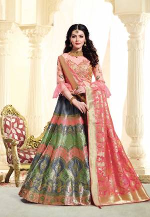 A Must Have Shade In Every Womens Wardrobe Is Here With This Designer Lehenga Choli In Peach Colored Blouse Paired With Multi Colored Lehenga And Peach Colored Dupatta. This Lehenga Choli IS Silk Based With Pretty Color Pallete. Buy Now.