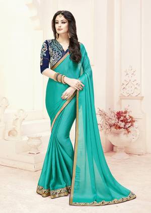 Grab This Beautiful Designer Saree For The Upcoming Festive Season With This Designer Saree In Turquoise Blue Color Paired With Navy Blue Colored Blouse. This Saree Is Fabricated On Satin Chiffon Paired With Art Silk Fabricated Blouse. 