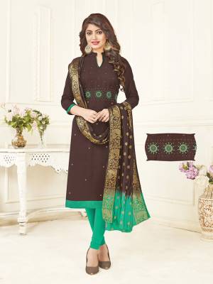 Add This Designer Dress Material To Your Wardrobe In Brown Colored Top Paired With Contrasting Sea Green Colored Bottom And Brown And Sea Green Shaded Dupatta. Its Top IS Fabricated On South Cotton Paired With Cotton Bottom And Banarasi Art Silk Dupatta.  Get This Stitched As Per Your Desired Fit And Comfort. 