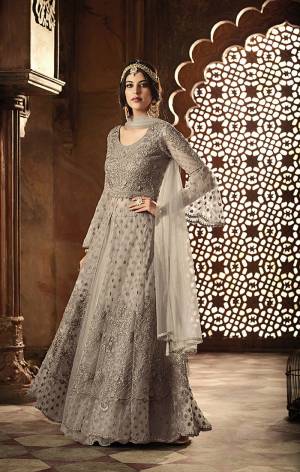 Flaunt Your Rich and Elegant Taste In This Elegant Grey Colored Designer Floor Length Suit. Its Heavy Embroidered Top IS Fabricated On Net Paired With Santoon Bottom And Net Fabricated Dupatta. Its Rich color And Heavy Embroidery Will Get you All The Atterntion.
